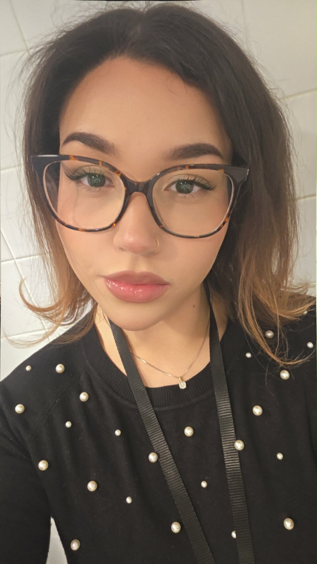 Luna wearing glasses and a black cardigan